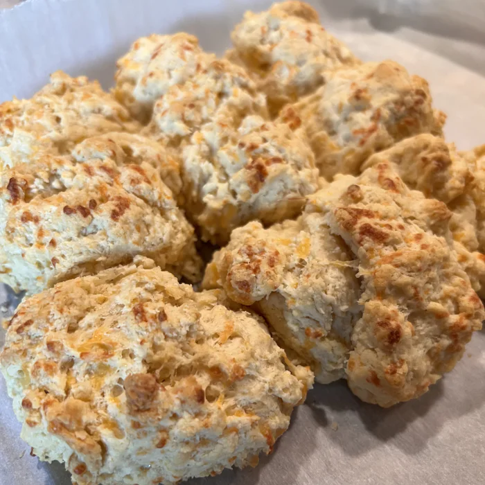 Cheddar sourdough biscuits cooling on parchment